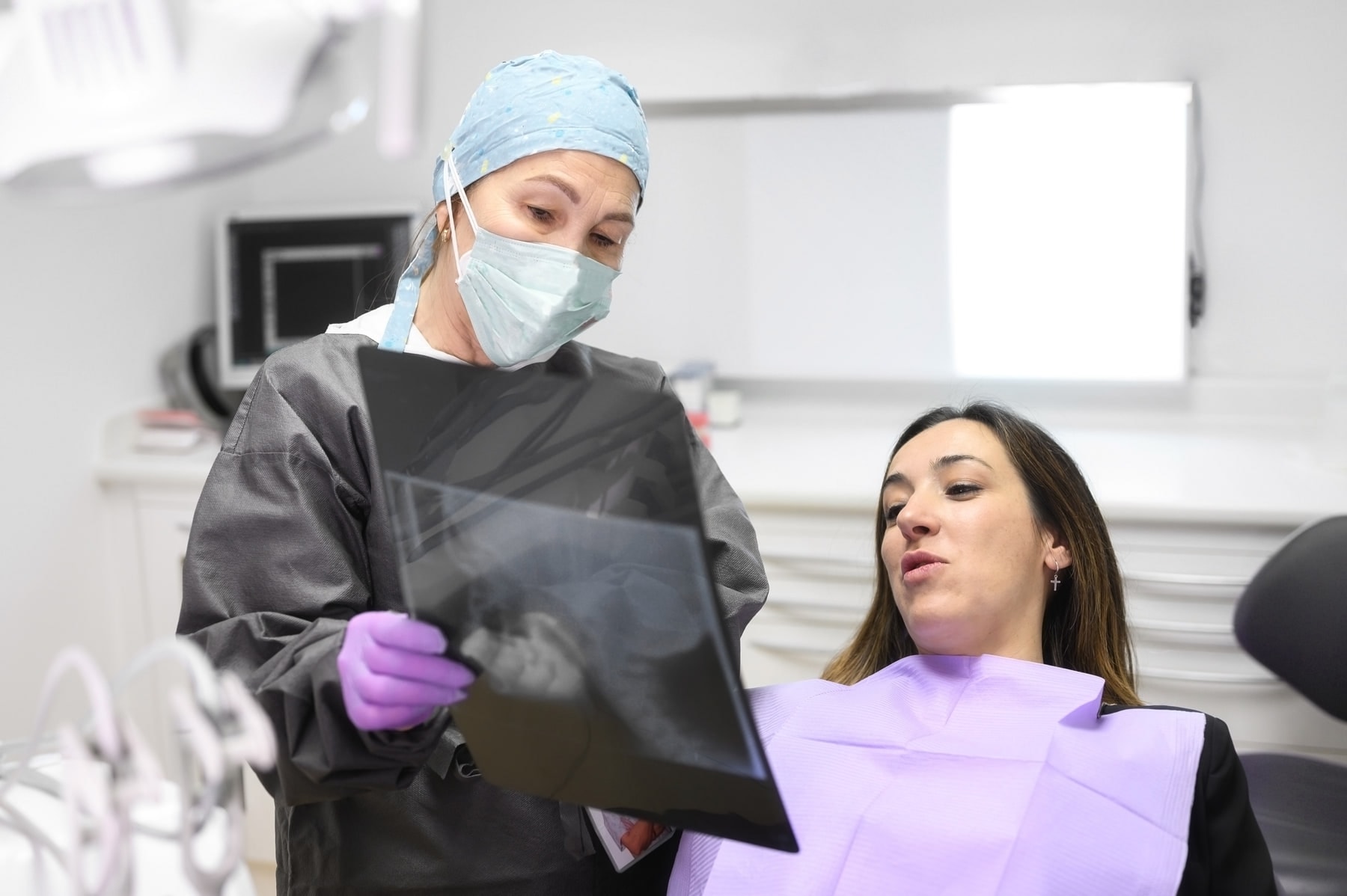 Dentist reviewing a dental X-ray with a patient