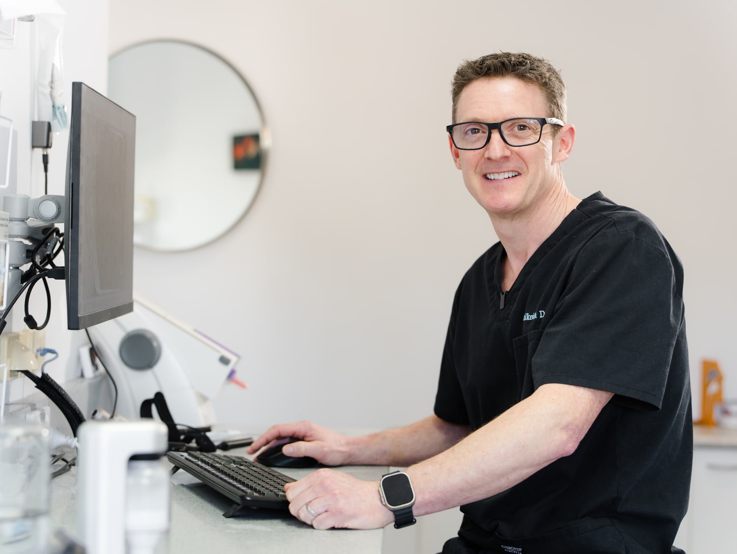 Dalkeith Dental dentist reviewing clinical records at a workstation