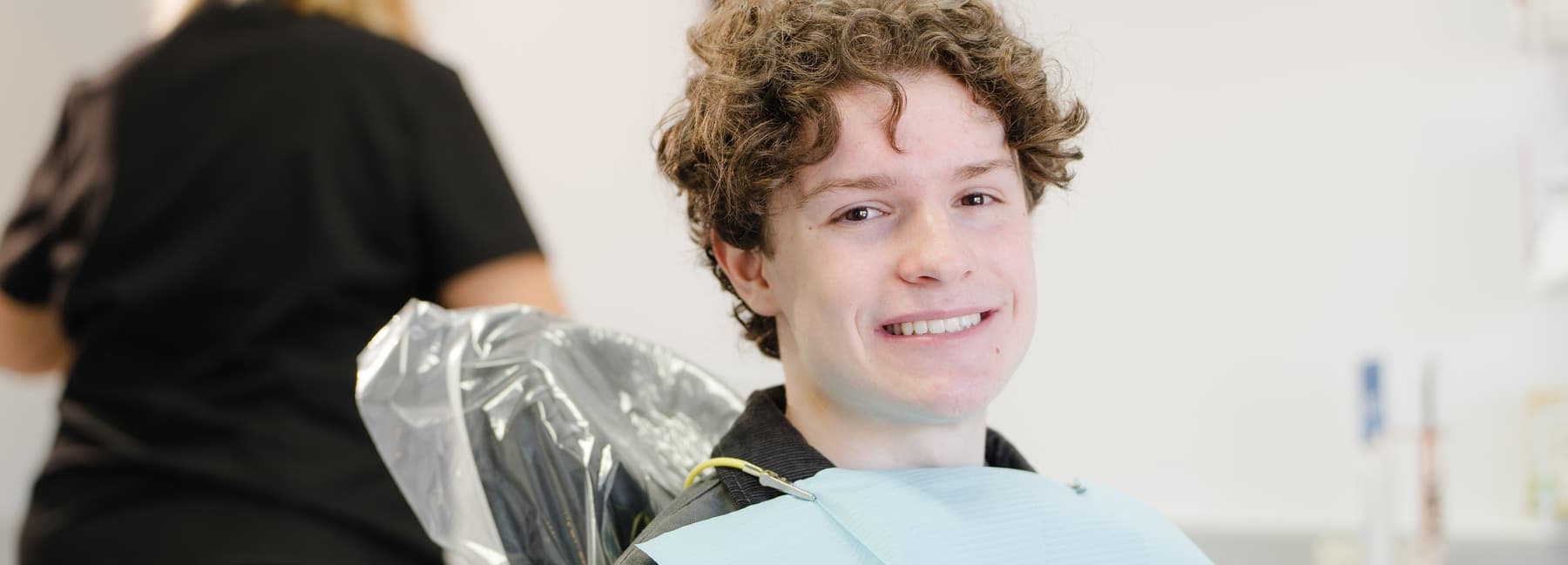 Young patient smiling in a dental chair at Dalkeith Dental