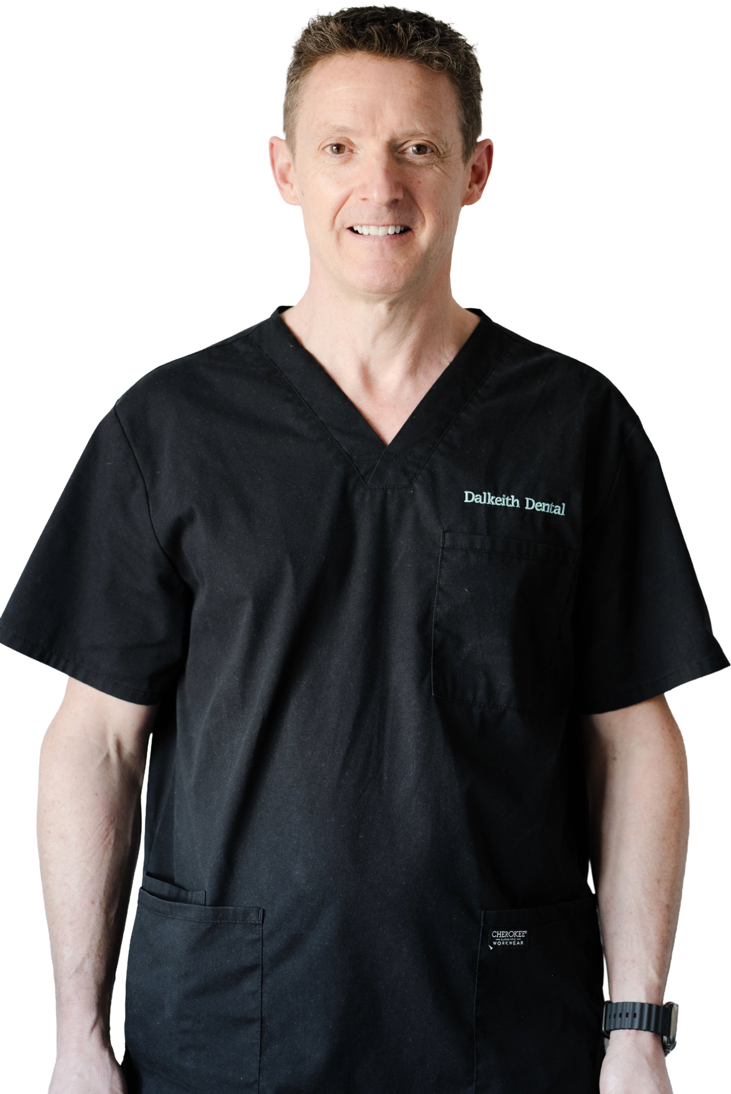 Dr Jeremy Gray smiling in black Dalkeith Dental scrubs